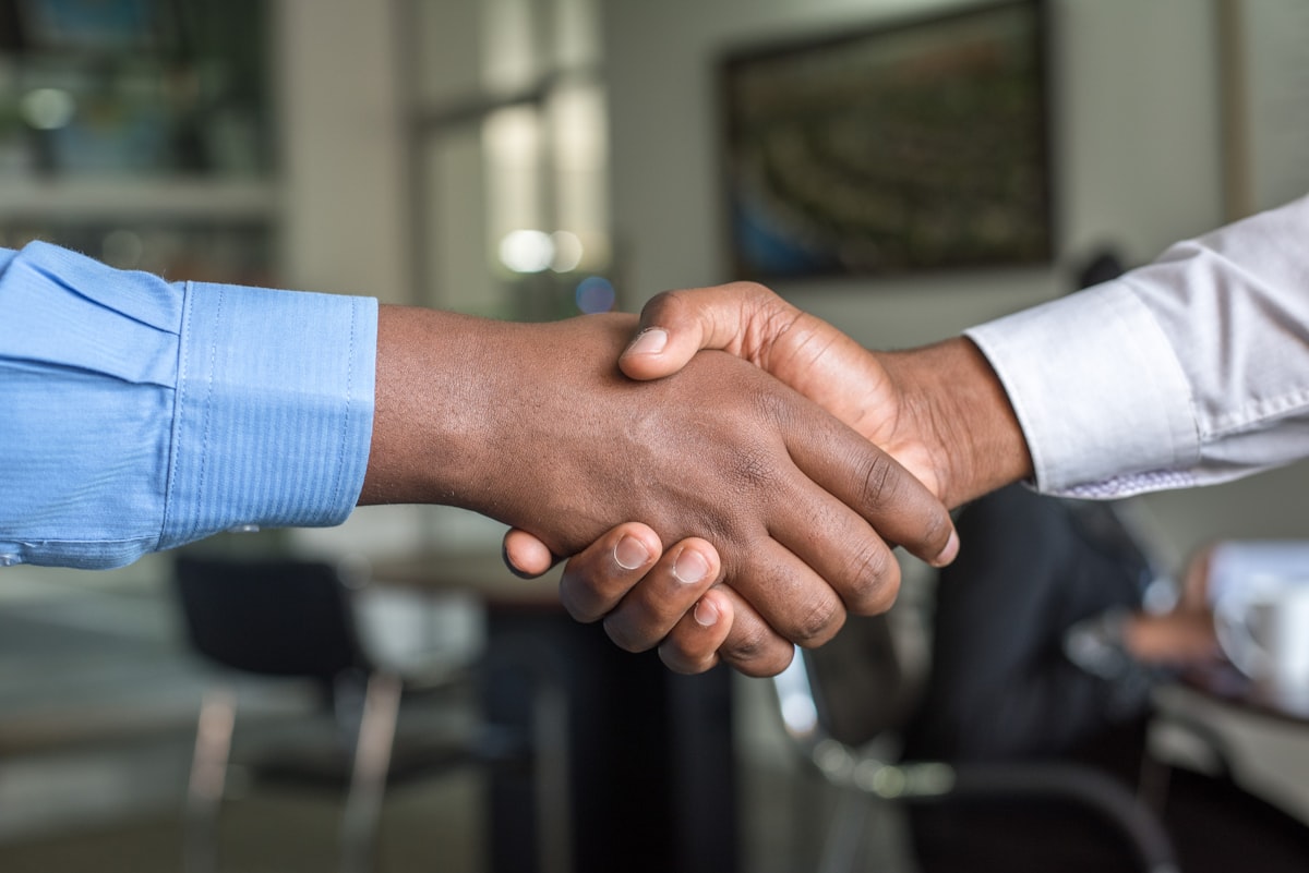 Two business owners shaking hands on a completed deal